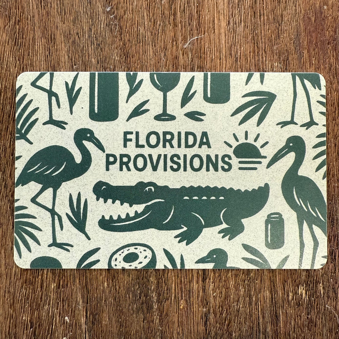 Florida Provisions gift card with nature-themed design on a wooden surface